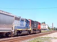 CN 5788 leads CSX 6084 eb throught Ingersoll Ontario 8-21-04