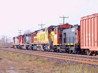 CN 2402 leads another CN unit, a UP and Canac 1389 switcher wb Ingersoll Ontario 10-23-04
