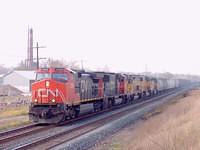CN 2599 lead another CN unit plus 3 UP's , one a tunnel motor eb through Ingersoll Ontario 10-23-04