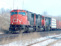 CN 5705 leads CSX 7849 through Beachville Ontario 3-11-05