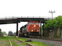 CN 5709 crawls along with 148 with WC 6917 trailing under the bridge at mile 55.5 Dundas sub after a hot wheel phone call alarm. 5-27-07