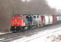 CN 5710 leads snoot nose HLCX 6230 and BNSF 8221 on 391 with 135 cars Ingersoll Ontario 1-28-07