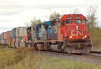 148 with CN 6007, CR (CSX) 5961, CN 9590, 120 cars climbs out of Woodstock Ontario 5-6-06
