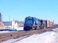 Conrail 5417 leads 327 through Ingersoll, MIle 59.0 Dundas Sub with a mixed train of boxcars & empty frame cars. 2/14/04