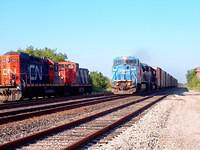 Conrail 8393 leads NS 2534 past CN 7068 and GMD 1430 on 328. Ingersoll Ontario 8-1-04