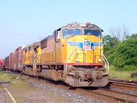UP 4371 SD70 leads 9476 C40-8w through Ingersoll on 328 6/29/04